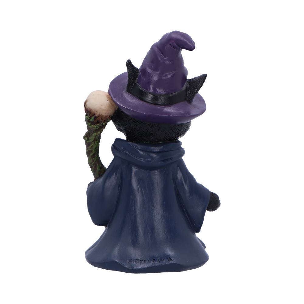 Witch figurine with a purple hat and blue cloak on a white background