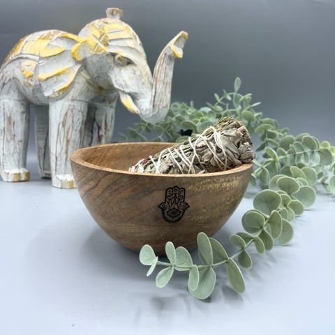 Channel protection and divine balance with this Wooden Smudge and Ritual Offerings Bowl – Hamsa Design, a beautifully handcrafted vessel infused with spiritual symbolism. Measuring 13 x 7cm, this wooden bowl is engraved with the Hamsa hand, an ancient emblem of protection, intuition, and harmony — said to ward off negative energy and invite blessings.
Perfect for holding smudging herbs, resins, crystals, or ritual offerings, the bowl’s natural wood grain and smooth finish bring a grounding, organic beauty