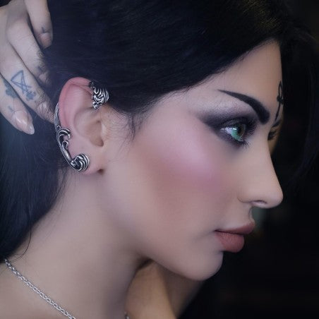 A breath-taking ear wrap (Ear Jewellery) handmade in antiqued and polished pewter featuring two baroque encased skulls.