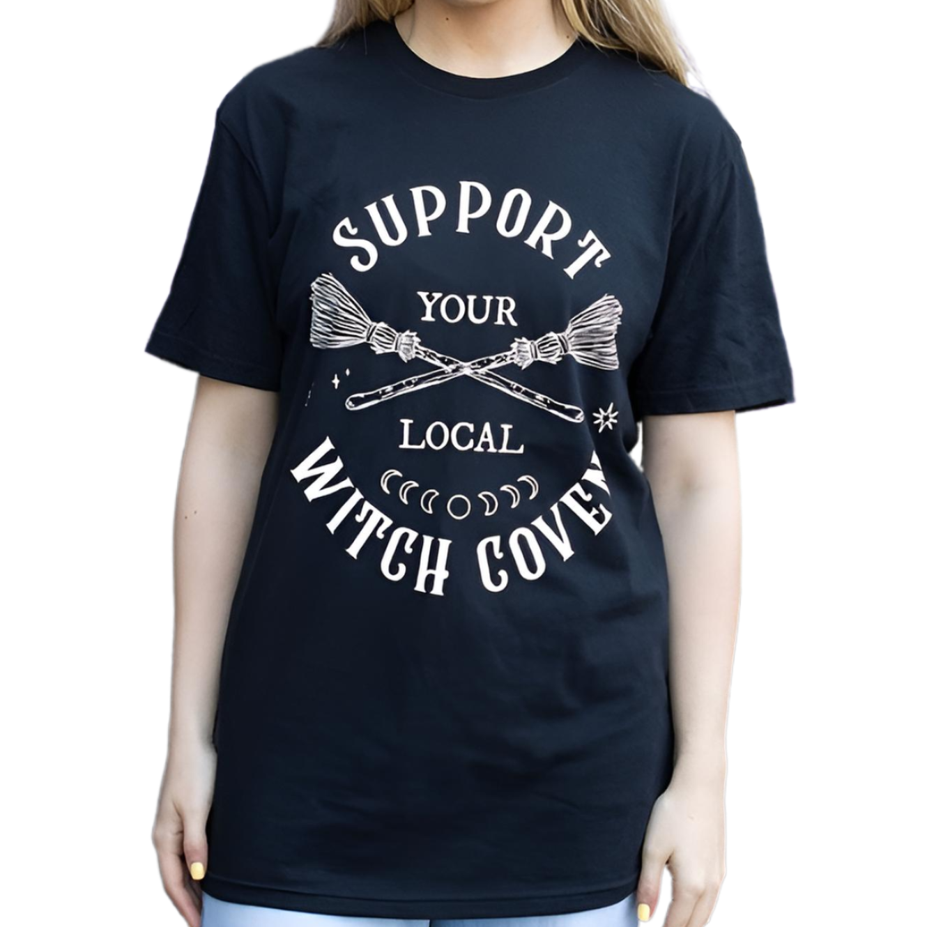 Show your support for the sisterhood with this unisex ‘Support Your Local Witch Coven’ T-shirt, crafted for witches, mystics, and seekers of the old ways.
This classic black cotton tee carries a powerful message: “Support Your Local Witch Coven,” adorned with a broomstick and moon phases – sacred symbols of unity, cycles, and magic. In witchcraft, the coven is not just a gathering, but a circle of shared strength, wisdom, and protection. Wearing this shirt honors that ancient bond, a sign that you stand wi