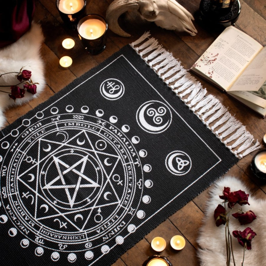 Enchant your altar with this handwoven Wiccan rug, featuring Sabbat symbols, moon phases & elements. Crafted in India from 100% cotton.