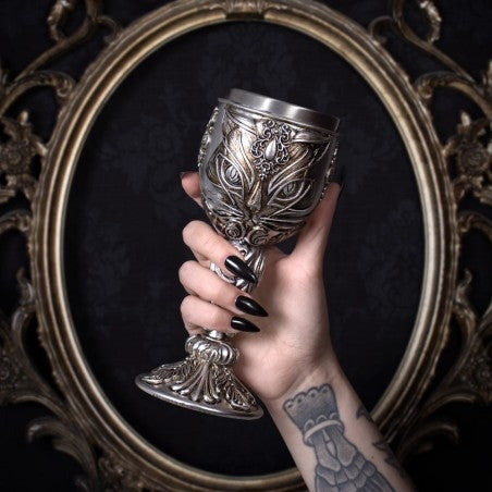 An impressive goblet to toast your celebratory occasions! Sip from the cup and you may divine the feline prophesies of Ailouros, heart spirit of the temple of Amun. Pray for her blessings, for she is the bringer of music, dance, good fortune, and joy to everyone.