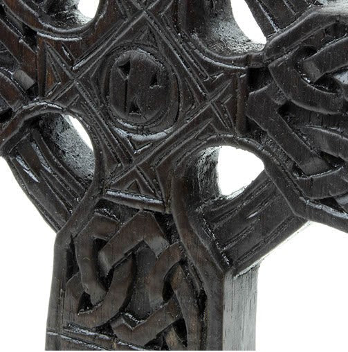 This chunky yet lightweight wooden carved Celtic cross stands on solid, sturdy base. This lovely little piece has carvings featuring Celtic style knots and etchings. Perfect for your mantlepiece or table.