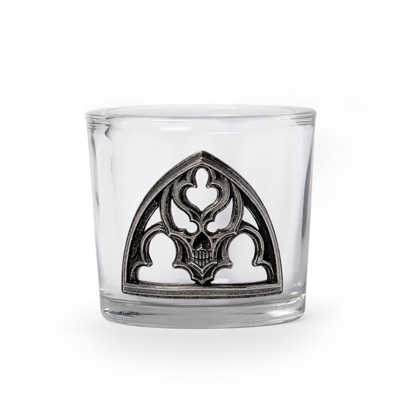 Clear glass with decorative metal emblem on a white background