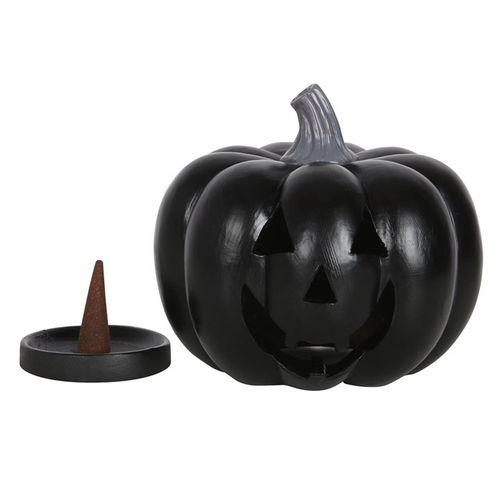 Black pumpkin-shaped candle with a pointed candle holder on a white background