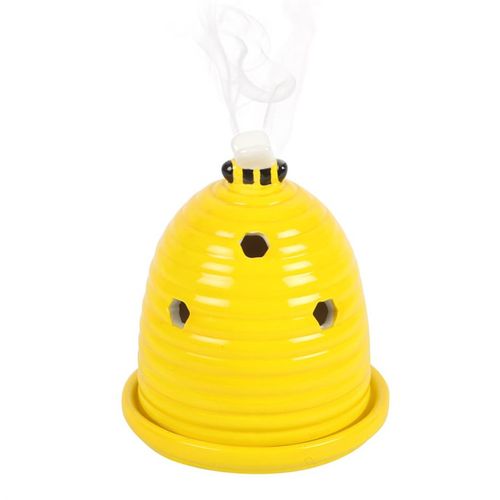 This charming ceramic incense cone holder, crafted in the form of a petite yellow beehive, invites a touch of magic to your space. Crowned with a delicate little bee, it casts an enchanting presence on any altar, side table, or nightstand, filling the air with mystical fragrances that awaken your spirit.