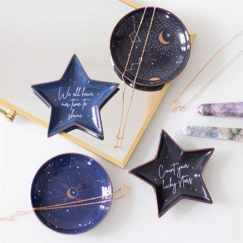 Navy blue ceramic jewelry trays with star designs and motivational phrases on a white background.