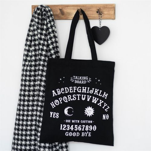 Perfect for doing the weekly shop, carrying library books, holding essentials for short day trips and more, this cotton tote bag makes a great eco-friendly addition to anyone's collection. Features a gothic talking board design printed on black inspired by classic Ouiji boards.