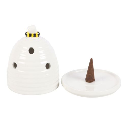 White ceramic incense burner with a small brown incense cone on a white background