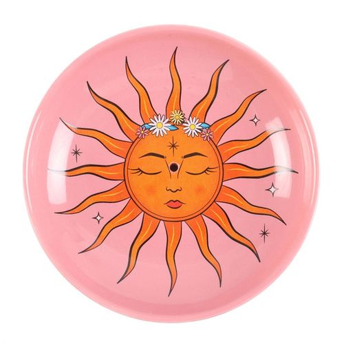 This contemporary incense holder showcases a vibrant sun motif drawn from 'The Sun' tarot card. Crafted from ceramic, it offers an enchanting and functional way to burn incense sticks. Place your glowing incense in the center or use it to keep tiny treasures safe on your altar, vanity, or nightstand.
