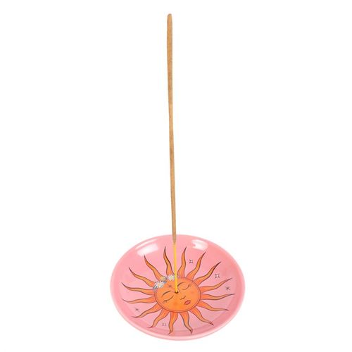 This contemporary incense holder showcases a vibrant sun motif drawn from 'The Sun' tarot card. Crafted from ceramic, it offers an enchanting and functional way to burn incense sticks. Place your glowing incense in the center or use it to keep tiny treasures safe on your altar, vanity, or nightstand.