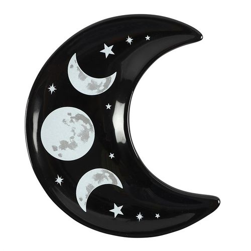 Embrace the magic of the night with this black Crescent Moon Trinket Dish, adorned with a captivating contemporary triple moon design. This enchanting dish is perfect for cradling your most treasured small jewellery—rings, earrings, and charms—keeping them safe within its mystical embrace. Crafted to evoke lunar energy, it measures H1.5cm x W10cm x D12cm, making it an elegant yet practical addition to your altar or dressing table. Packaged carefully at H2.3cm x W10.2cm x D12.5cm, it arrives ready to hold yo