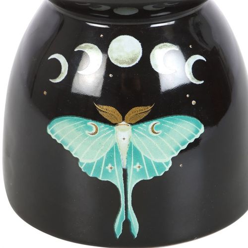 Infuse your sacred space with the magickal energy of transformation and lunar guidance. This captivating black oil burner features the elegant luna moth — a symbol of spiritual rebirth — framed by silvery moon phases to invoke intuition, reflection, and divine femininity.
Place your favorite essential oil or wax melt in the dish above and allow its gentle aroma to awaken your senses and elevate your home's vibration. Whether used during meditation, ritual, or daily relaxation, this enchanting piece is more