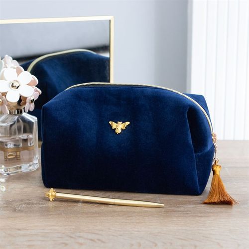 This elegant zippered bag is ideal for storing toiletries and features a gold tone bee accent and matching tassel. The stylish bag is ideal for the home bathroom and perfect for travel.