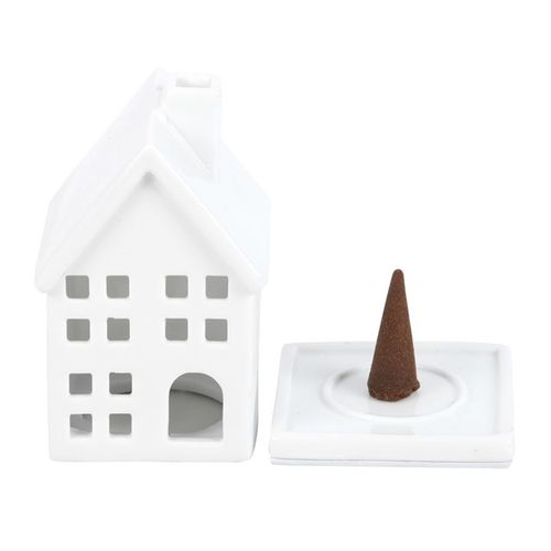 White house-shaped incense burner with a brown incense cone on a white background