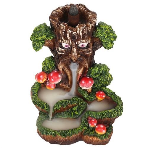 Decorative tree-like sculpture with eyes, nose, and mouth, surrounded by leaves and berries on a white background.