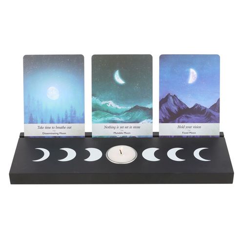 Display tarot card readings with this black wooden moon phases tarot card stand, complete with two spaces for holding tealight candles to create ambiance and allow the meaning of the cards to resonate. Whether it's used for displaying treasured tarot cards for their meaning or their unique design, this piece will add mystical allure to any home.