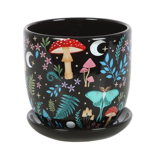 Envelop your cherished plants in the enchanting embrace of this Dark Forest Print Ceramic Plant Pot with Saucer. Adorned with vivid illustrations of mystical flora and elusive woodland creatures, it captures the secret magic of the forest under moonlit skies. Speckled with delicate moons and stars, this pot invites a touch of celestial wonder to your sacred space. Perfect for nurturing your most treasured houseplants, it transforms any corner into a mystical garden where nature’s whispers and ancient spells