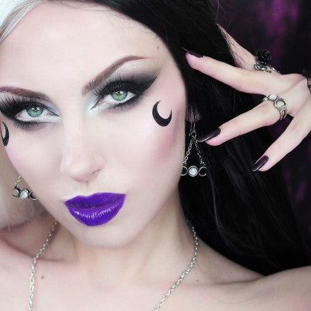 The pearly full moon flanked by the waxing and waning crescents symbolise the Triple Goddess of Wicca; the Maiden, the Mother and the Crone, invoking, amongst other attributes healing, occult protection, perfection and wealth.