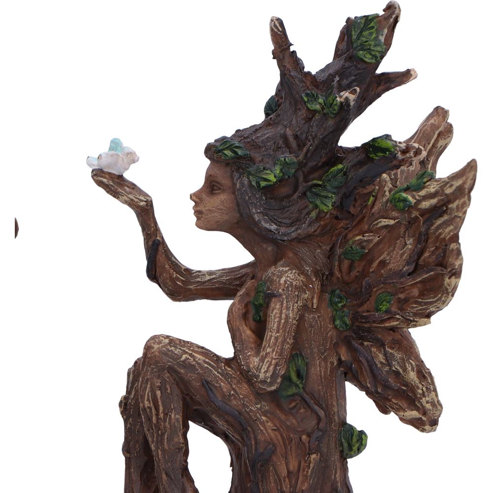 Statue of a nature-themed figure with tree-like branches and leaves on a white background