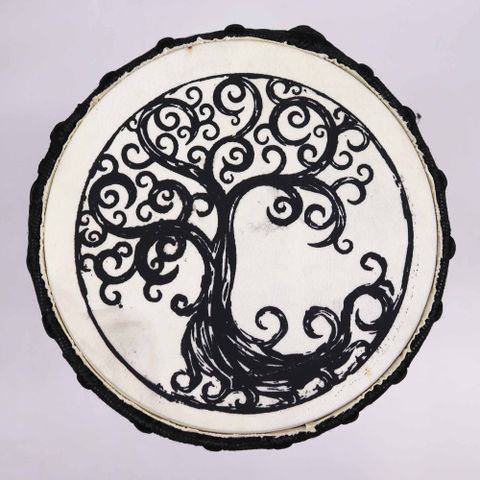 Immerse yourself in rhythm and symbolism with our 40cm Wide Top Djembe Drum featuring the Tree of Life design. Handcrafted in the West African tradition, this djembe boasts a distinctive flared top that offers a broader playing surface and deeper resonance.

The Tree of Life, beautifully illustrated on the drum skin, embodies spiritual connection, the cycle of life, and the harmony between all living things.

Both a powerful percussion instrument and a symbolic work of art, this drum is ideal for drumming c