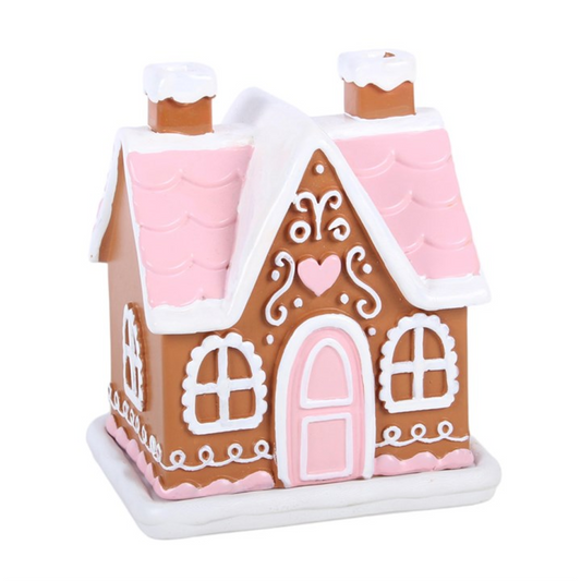 Gingerbread house model with pink roof and white decorations on a white background
