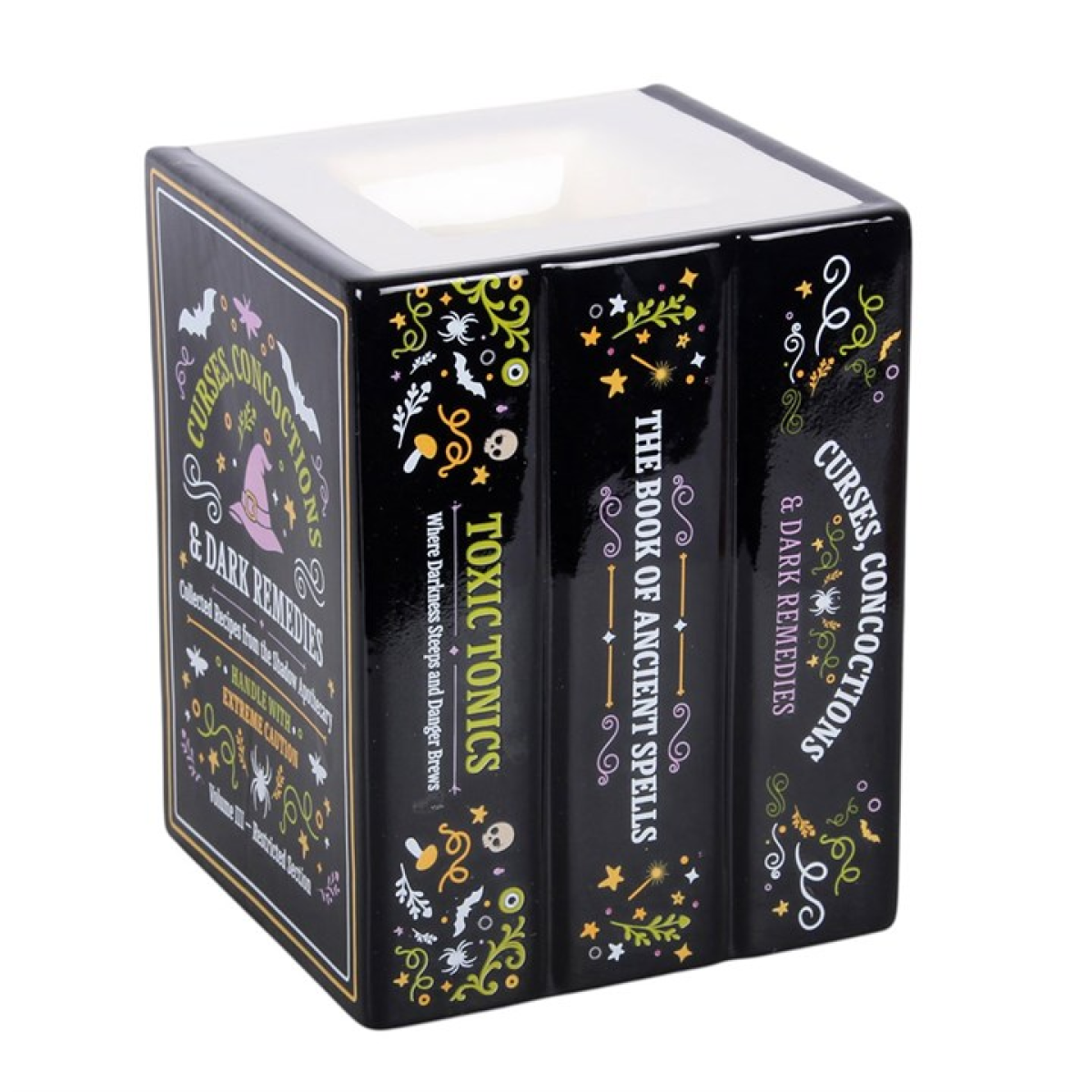 Add a touch of dark curiosity to the home with this ceramic oil burner and wax warmer designed to look like a stack of miniature spell books. Featuring detailed titles including “Toxic Tonics”, “The Book of Ancient Spells and Curses”, and “Concoctions and Dark Remedies”, this piece is perfect for Halloween displays or for those who enjoy gothic-inspired home fragrance. Simply place a standard tealight in the back and add diluted fragrance oil or wax melts in the top dish.