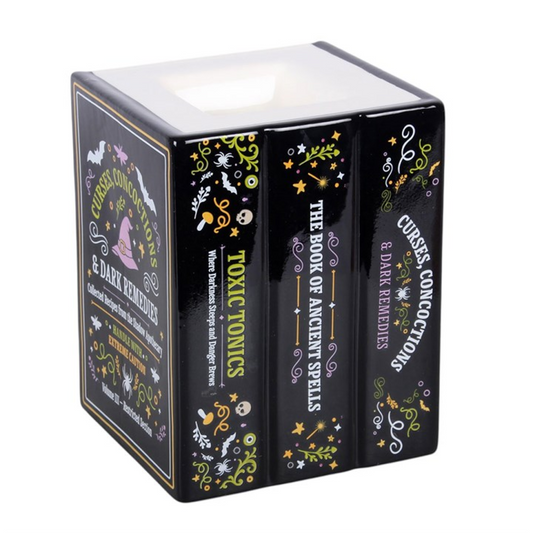Add a touch of dark curiosity to the home with this ceramic oil burner and wax warmer designed to look like a stack of miniature spell books. Featuring detailed titles including “Toxic Tonics”, “The Book of Ancient Spells and Curses”, and “Concoctions and Dark Remedies”, this piece is perfect for Halloween displays or for those who enjoy gothic-inspired home fragrance. Simply place a standard tealight in the back and add diluted fragrance oil or wax melts in the top dish.