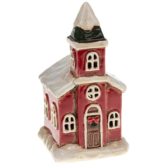 Handcrafted in the Village Pottery workshop, this charming Christmas Church tealight holder captures the warmth and spirit of the season. Made from ceramic with traditional detailing, it evokes the timeless beauty of a snow-covered village church. Measuring 14.5 x 7.5 x 7 cm, this small tealight house glows beautifully when lit, filling your home with a cosy festive atmosphere. Perfect for mantelpieces, shelves, or part of a winter village display, this ceramic tealight church is a keepsake piece designed t