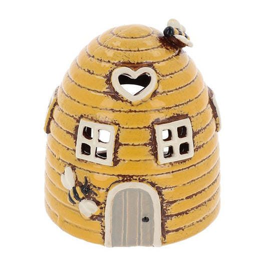 Invite the gentle energy of the hive into your home with this Village Pottery Mini Beehive Tealight Holder. 🍯🐝✨

Lovingly handcrafted and cloaked in a cheerful sunny yellow glaze, this whimsical ceramic beehive stands at 11.5cm tall. With delicate cut-out windows, it casts a soft, flickering glow when a tealight is placed inside—bringing warmth, joy, and a touch of rustic magic to any space.

Perfect for witches of the garden, lovers of bees, and those who cherish handcrafted decor, this little hive looks