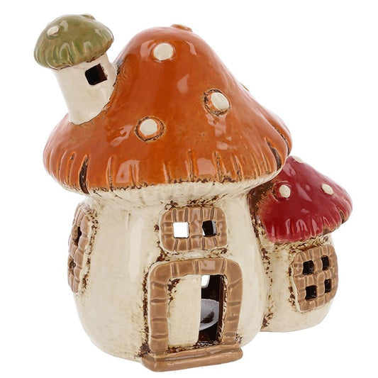 Bring a touch of magic and warmth to your home or garden with the Village Pottery 2 Mushroom House Tealight Holder. Handcrafted with care, this charming ceramic tealight holder features two quaint mushroom houses that cast a soft, enchanting glow, perfect for creating a cozy atmosphere in any space.

Ideal for indoor or outdoor use, the rustic design fits beautifully with whimsical, cottagecore, or witchy décor styles. Whether placed on your windowsill, garden table, or altar, it’s a delightful addition to 