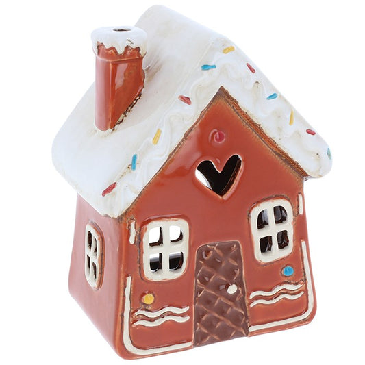 Let your hearth be merry and bright with this Village Pottery Gingerbread House Swirls Tealight, a sweet little cottage steeped in festive magic. 🏠✨🕯️

Crafted from ceramic and finished in a rich gingerbread brown glaze, this whimsical house is adorned with icing swirls, sprinkle details, and windows that glow when lit from within. Simply place a tealight inside and watch as your space fills with warm, enchanting light—like a beacon from a snow-dusted forest village.

Whether perched upon a shelf, nestled