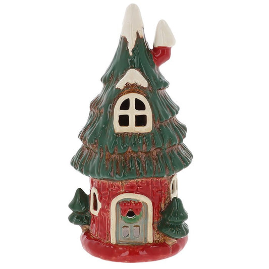 Celebrate the magic of the season with the Village Pottery Christmas Tree House Tealight Holder, a beautifully handcrafted ceramic cottage inspired by the spirit of Christmas. Designed as a charming tree-shaped home with intricate detailing, this festive piece brings a touch of woodland wonder to your winter décor.

When lit, the gentle glow of the tealight shines through its tiny windows, illuminating the tree’s festive form and creating a warm, peaceful atmosphere. Each holder is carefully handmade in the