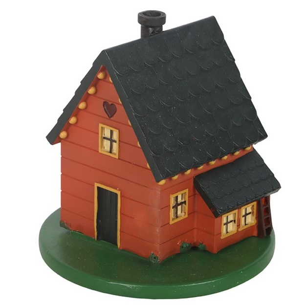 Small model of a wooden cabin with a black roof on a white background