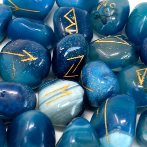 Unlock ancient runic wisdom with this enchanting Blue Onyx Rune Set. Each handcrafted set includes 25 polished stones: 24 engraved with traditional Elder Futhark runes and one blank stone, representing the unknowable.

Housed in a soft pouch for safekeeping, these rune stones are perfect for practitioners of divination, meditation, and spiritual reflection. Whether you're new to runes or an experienced reader, Blue Onyx enhances clarity and focus during readings.

Blue Onyx is known for its grounding energy