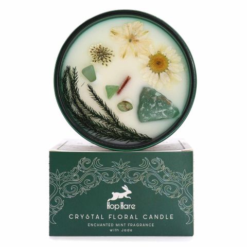 Enter a realm of enchantment with the Hop Hare Crystal Magic Flower Candle - The Magician. Infused with Jade crystal and adorned with delicate dried flowers, this candle carries a tarot card revealing a mystical tale. Its scent blends invigorating Enchanted Mint with top notes of spearmint and lime, heart notes of bergamot and green tea, and a grounding base of vetiver and musk. With a burn time of 22 hours, it invites you to experience transformation and botanical magic in every flicker. Discover the story