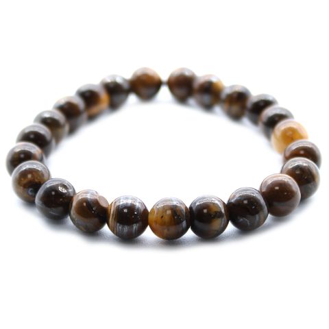 Harness the grounding power of the Earth with this Tiger Eye Power Bracelet—a radiant talisman for courage, clarity, and emotional balance. As a crystal healer, I often turn to Tiger Eye for those seeking strength through life’s transitions. Its golden-brown bands shimmer like sunlight through the forest, connecting you to the steady rhythm of nature and your own inner wisdom.

Tiger Eye is believed to balance the lower chakras, easing fear and anxiety while encouraging grounded decision-making and personal