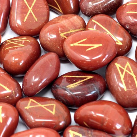 Unlock powerful divination and guidance with our Runes Stone Set, featuring 25 carefully crafted semi-precious stones, including 24 etched with ancient rune symbols and one blank stone for personal intuition. Each stone is made from vibrant Red Jasper, known for its grounding and protective qualities. Perfect for enhancing meditation, boosting creativity, and fostering emotional balance, this rune set is a sacred tool for spiritual seekers and witches alike. Comes with a handy pouch for safe storage and eas