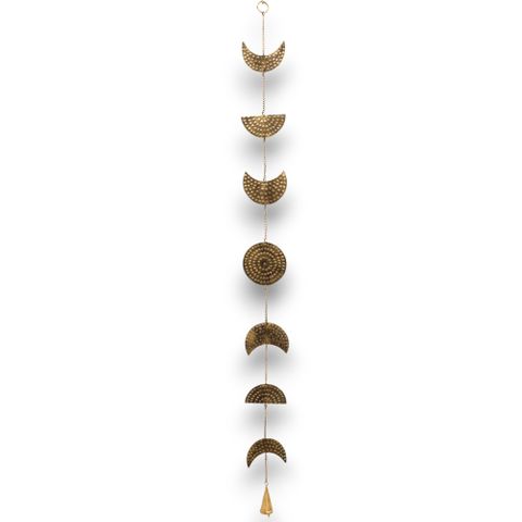 This enchanting 25 cm brass chime, handcrafted in India, captures the magic of the moon’s phases, weaving the rhythm of time and renewal into your surroundings. Its delicate cascade of lunar symbols culminates in a lone brass bell that sings soft, calming notes with every whisper of the wind, inviting a serene, mystical energy into your space.
