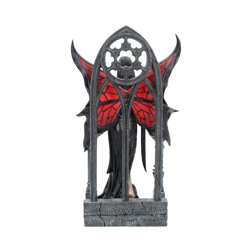 Statue of a fairy with red wings and black body on a white background