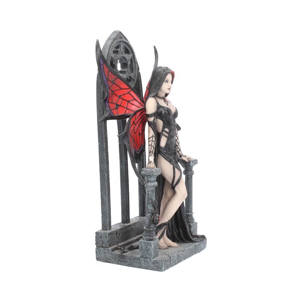 Statue of a fairy with red wings on a stone throne against a white background