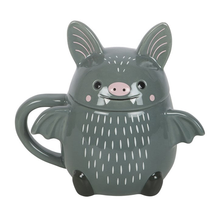 Make every sip a little more fun with this adorable bat-shaped ceramic mug, complete with a matching lid featuring sweet little ears and a smiling face. Perfect for Halloween lovers or cute and quirky drinkware all year round. Do not microwave. Hand wash only.
