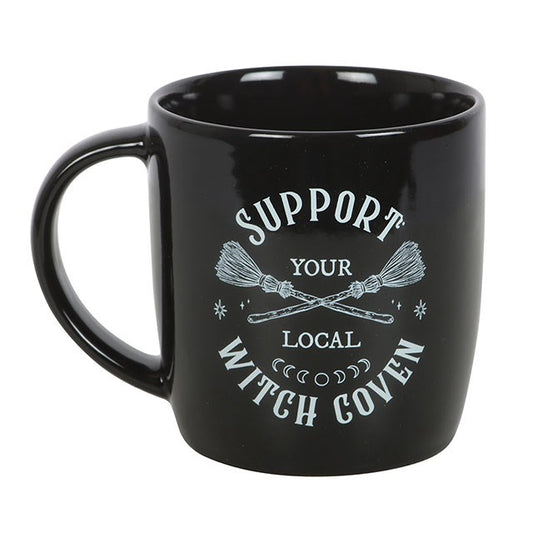 This Support Your Local Witch Coven Mug is more than just a vessel for coffee or tea – it’s a proud statement of unity, magic, and community. Crafted in sleek black ceramic, it features two crossed broomsticks and the bold phrase Support Your Local Witch Coven in striking white.

In folklore, covens are sacred gatherings of witches, a circle where wisdom, spells, and energy are shared. To “support your local coven” is to honour the spirit of witchcraft, connection, and strength found in unity. Whether you a