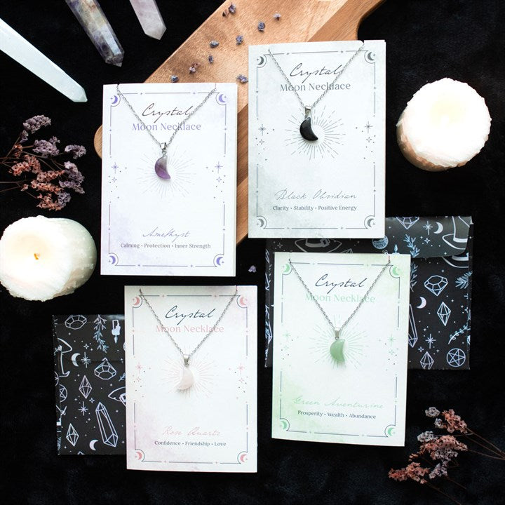 Crystal necklaces on cards with decorative elements on a dark background
