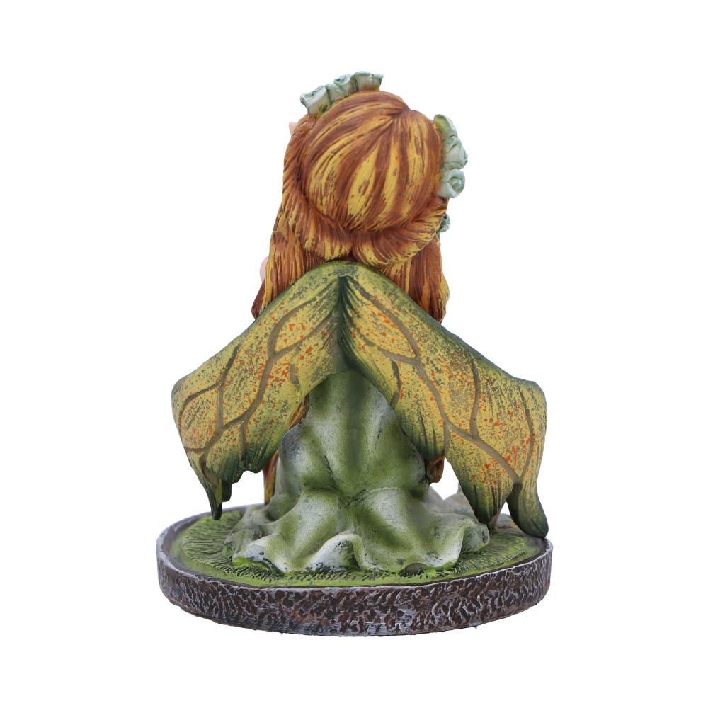 Fairy figurine with green dress and brown hair on a white background