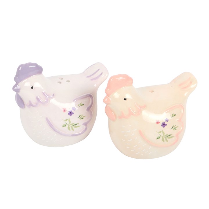 Ceramic hen salt and pepper shakers with pastel tones and floral accents. Charming, practical kitchen accessories and perfect gift for farmhouse lovers.