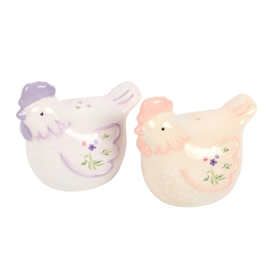 Ceramic hen salt and pepper shakers with pastel tones and floral accents. Charming, practical kitchen accessories and perfect gift for farmhouse lovers.