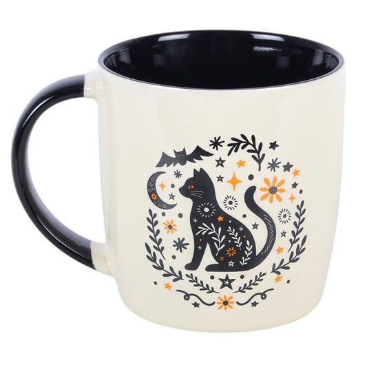 Enjoy a warm drink in seasonal style with this ceramic mug, featuring a folk-inspired black cat design with simple floral and nature details. Perfect for autumn days at home, it makes a thoughtful gift for anyone who enjoys themed kitchenware and cosy moments. Ideal for tea, coffee, or hot chocolate. Microwave safe. Dishwasher safe.