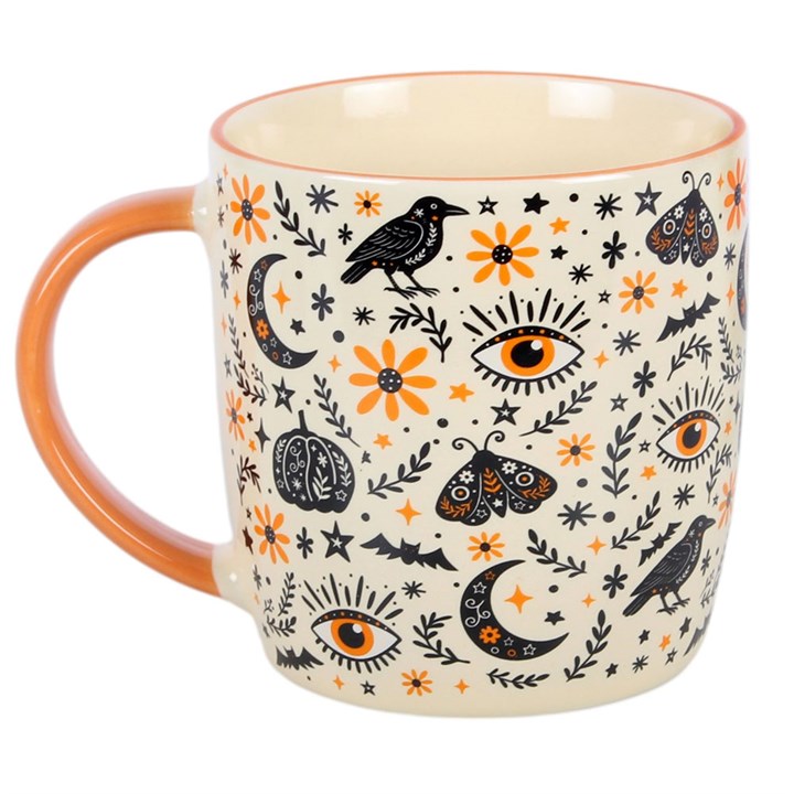 Enjoy a warm drink in seasonal style with this ceramic mug, featuring an all-over folk-inspired print with autumn motifs including ravens, moths, moons, and florals. Perfect for autumn days at home, it makes a thoughtful gift for those who enjoy themed kitchenware and decorative designs. Ideal for tea, coffee, or hot chocolate. Microwave safe. Dishwasher safe.