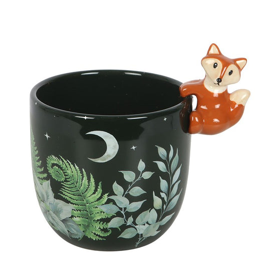 Black mug with a fox handle featuring nature-themed design on a white background